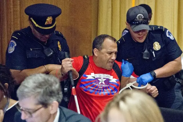 A protester is forcibly removed from the room by U.S. Capitol Police as the Senate Committee on Finance was to conduct the "Hearing to Consider the Graham-Cassidy-Heller-Johnson Proposal" on the repeal and replace of the Affordable Care Act